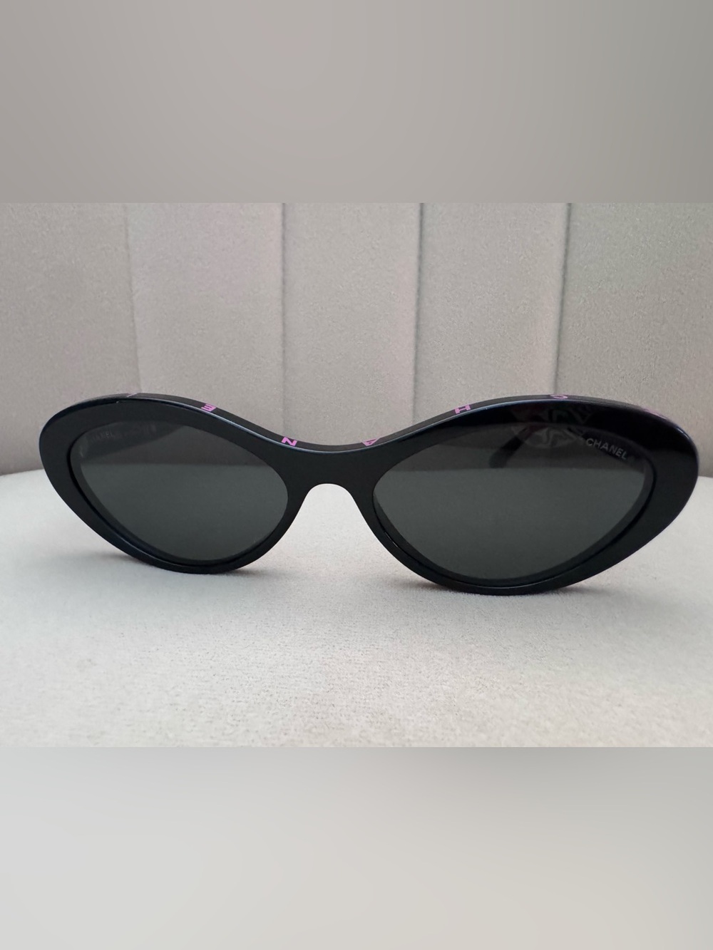 CHANEL Oval Black Sunglasses with Pink Lettering